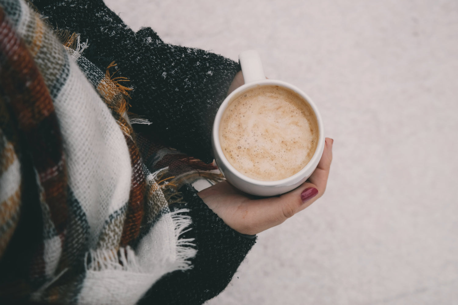 Woman holding coffee cup in winter